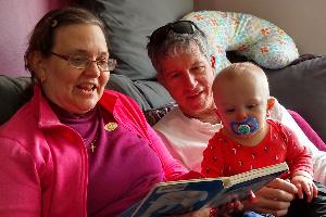 VJ with Chuck reading to their grandson Oliver