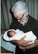 Jim holding newborn granddaughter Megan (1987)