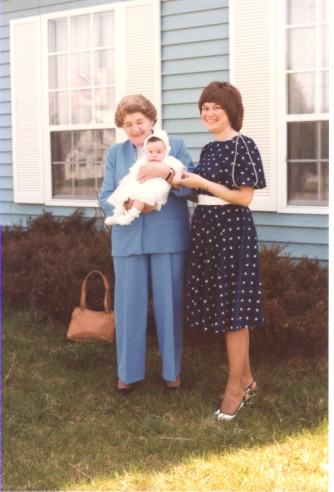 Yes, that sweet little baby is me.  My nonna is the one holding me while standing beside my mom.