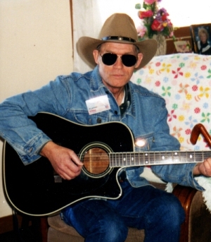 Jim playing his guitar and singing a cowboy song.